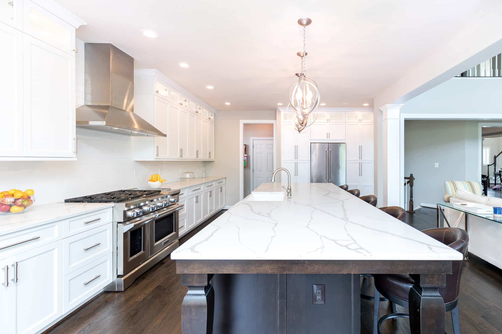 Contemporary kitchen design with white cabinets and marble counter tops