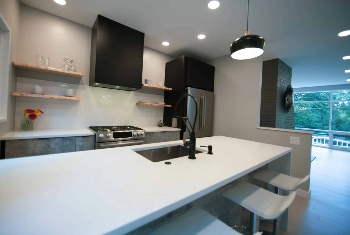 How Much Does a 10×10 Kitchen Remodel Cost in 2026? 22 Modern kitchen with Perla White quartz island, slab cabinetry, and Artesso by Brizo matte black faucet