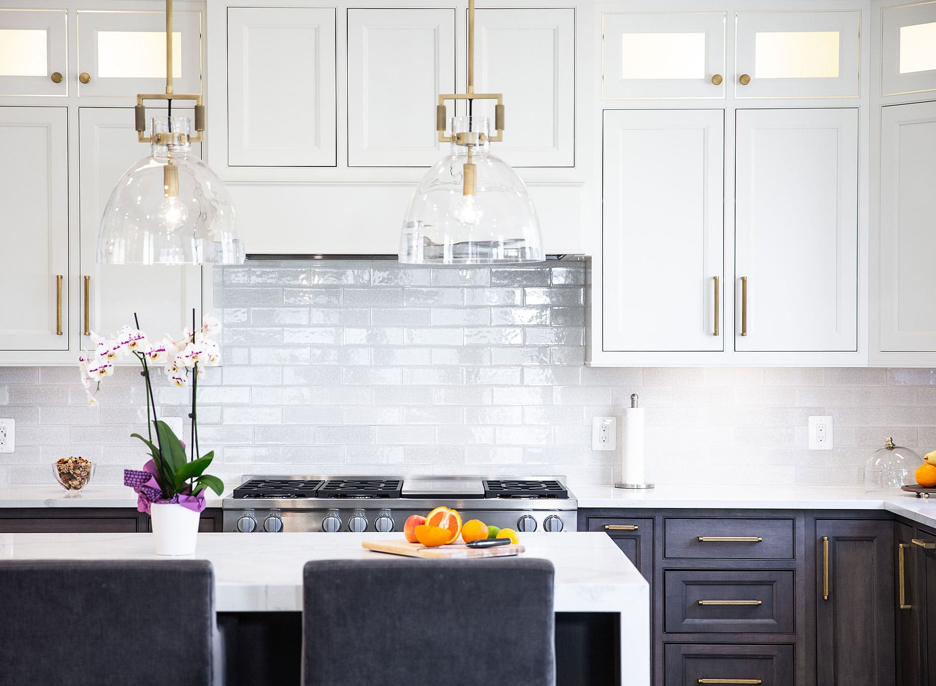 white kitchen cabinets and black chairs