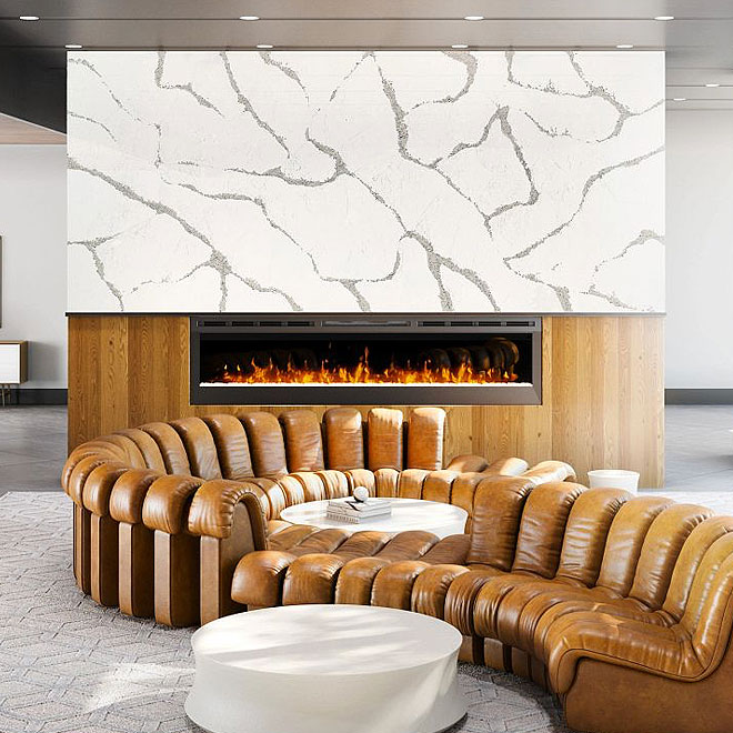 Cambria 10 Modern living room with a large, curved brown leather sectional sofa in front of a linear fireplace