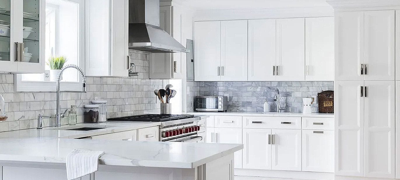 Fabuwood Allure kitchen with white shaker cabinets and a large marble-top island