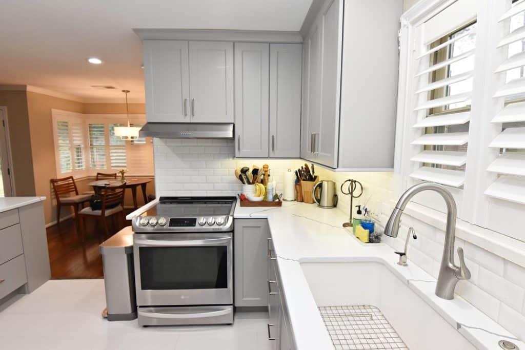 10 Ideas for a Small Kitchen Remodel on a Budget 8 A modern kitchen with sleek stainless steel appliances and pristine gray cabinets
