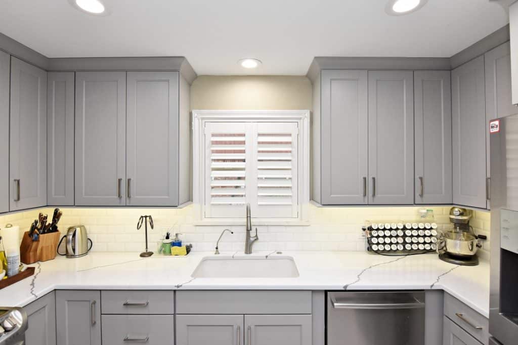 Need Low-Cost Kitchen Cabinets with High Style? 9 A kitchen with sleek gray cabinets and white marble countertops