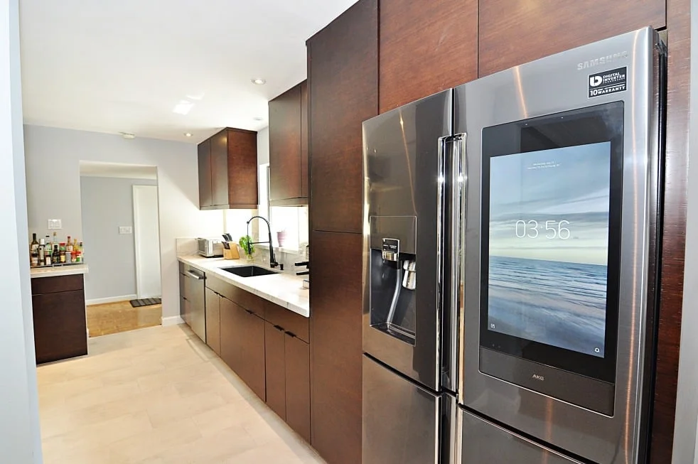 Contemporary Houston kitchen with Ultracraft chocolate bamboo cabinets and stainless appliances