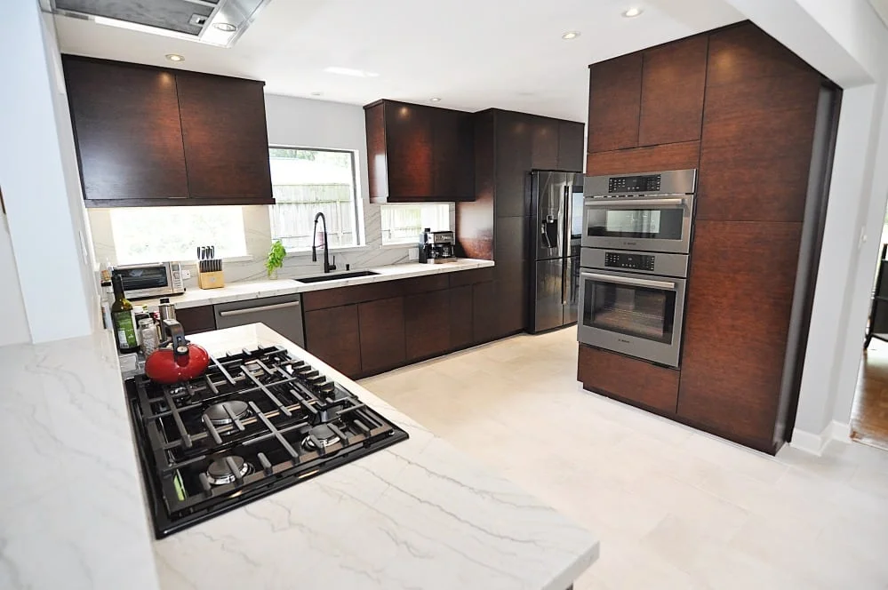 Dark wood bamboo cabinets with stainless steel appliances in Houston kitchen remodel