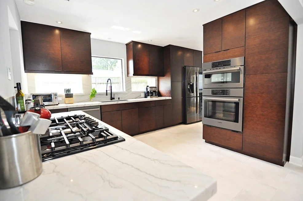 Houston TX kitchen remodel featuring Ultracraft brown bamboo cabinets and stainless steel appliances