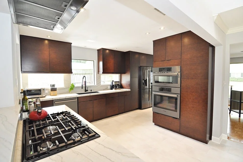 Kitchen island with brown bamboo cabinets and White Macaubas countertop in Houston TX