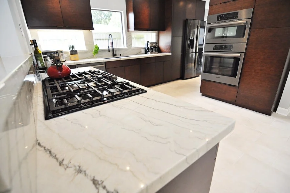 MSI White Macaubas marble countertops with brown Ultracraft cabinets in Houston