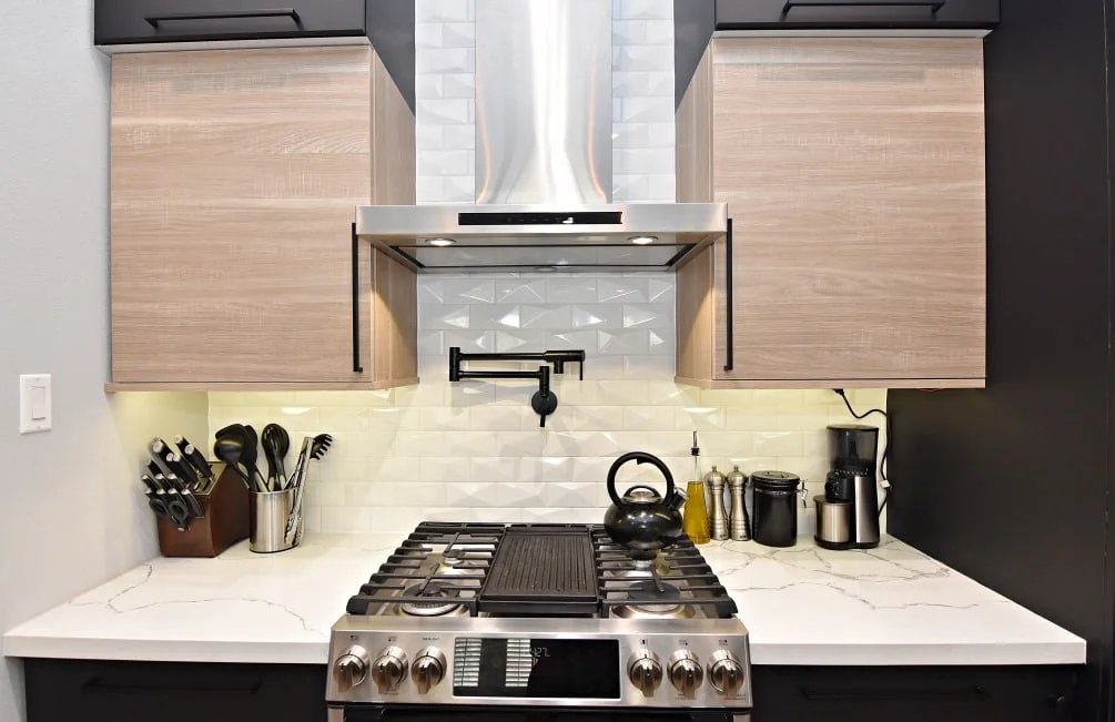 Sleek modern kitchen with Ultracraft black matte cabinets and clean design