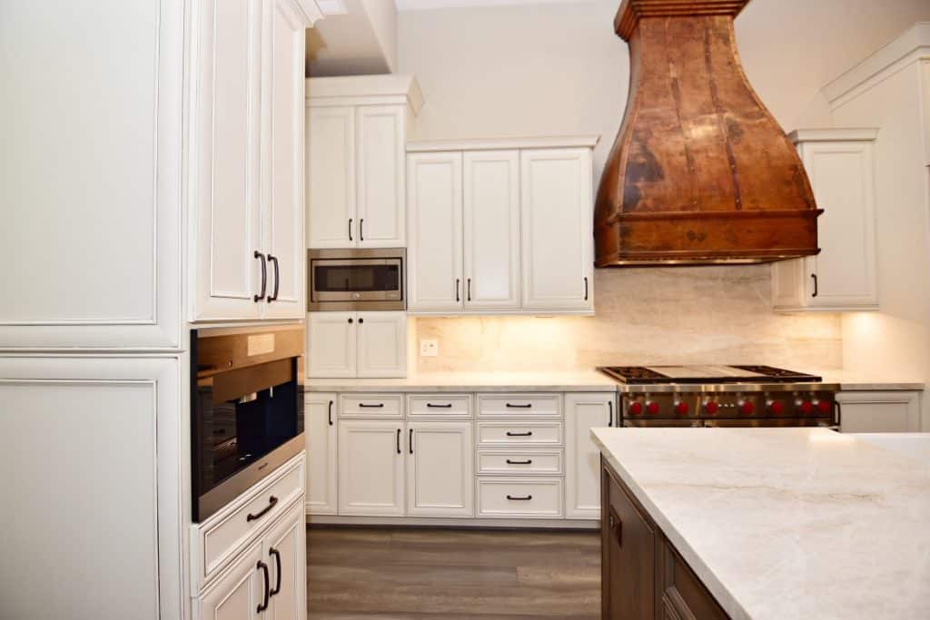 7 Smart Strategies for Kitchen Remodeling 6 Sleek white cabinets and stove in a kitchen setting