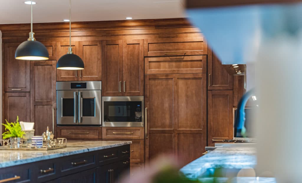 Ways On How To Protect Your Kitchen Cabinets From Humidification 29 Kitchen with wooden cabinets and center island, featuring modern design and stainless steel appliances