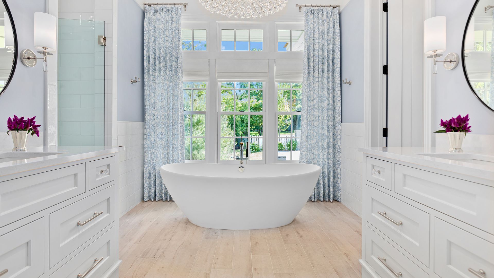Freestanding Bathtub With Ornate Iron Screen And Oblong Vanity Mirror