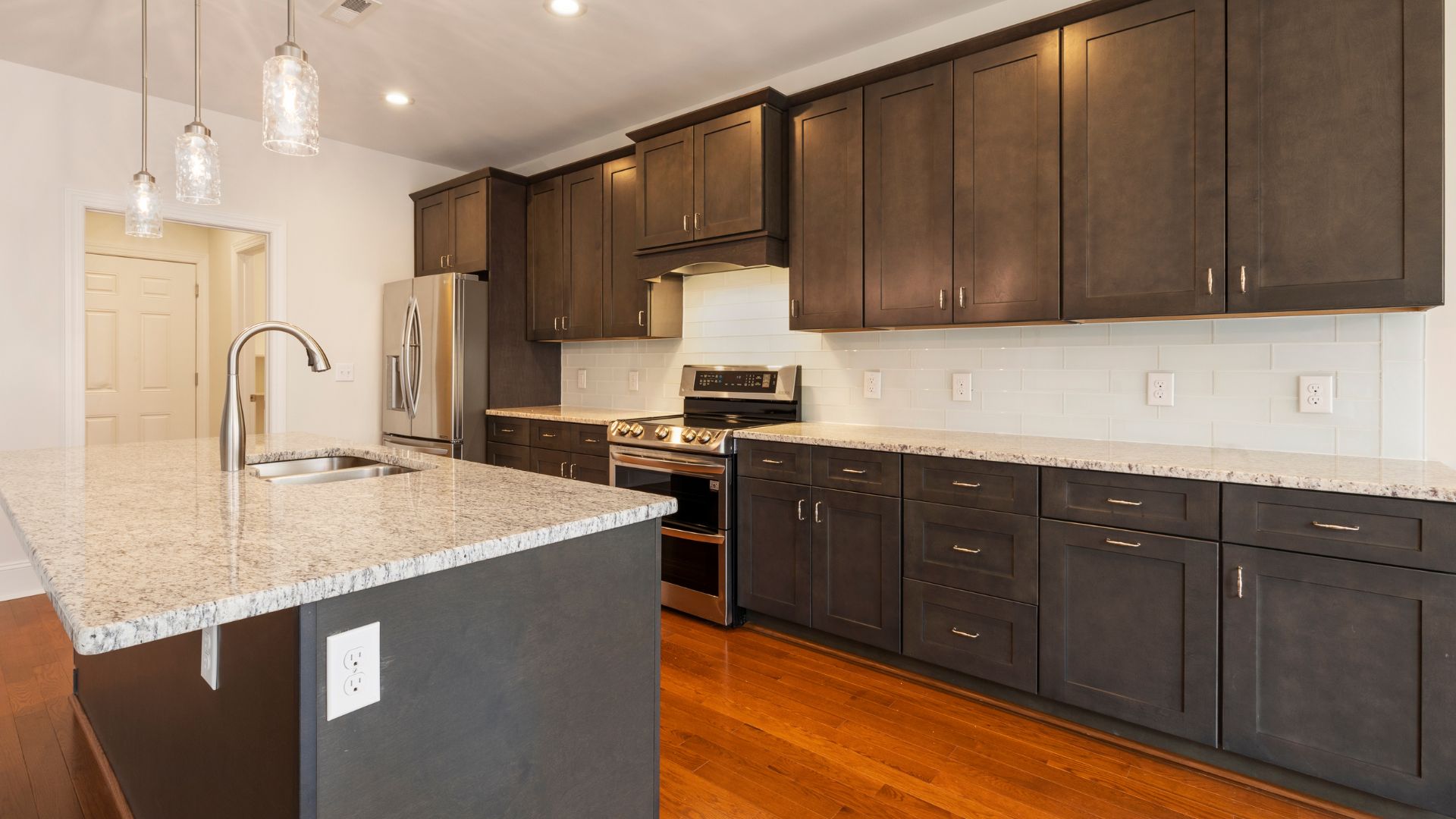 brown kitchen with a marble counter top