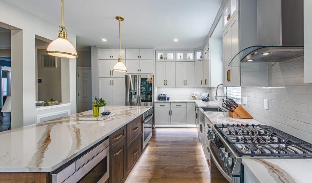 A Detailed Look at Kitchen Remodeling Costs and Components 13 A kitchen with white cabinets and gold accents