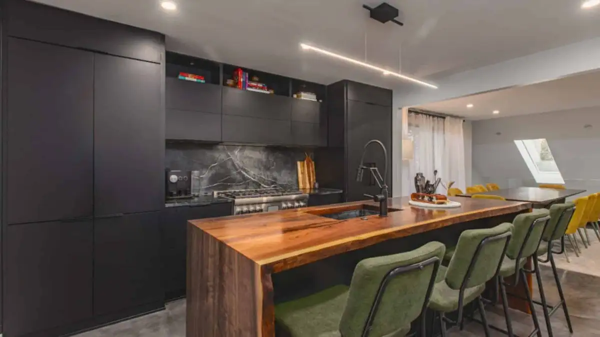Kitchen remodeled with Black Cabinets and Wooden Countertops