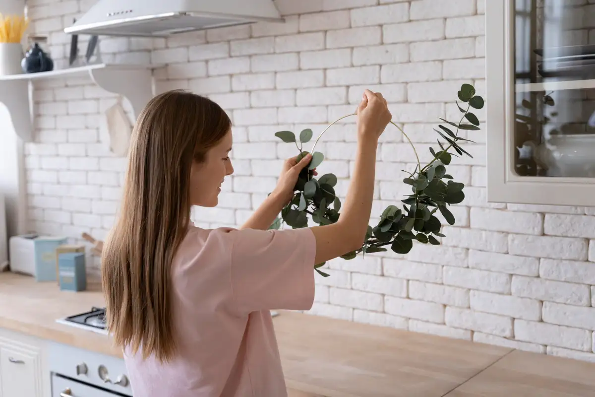 grey kitchen with plants over cabinets