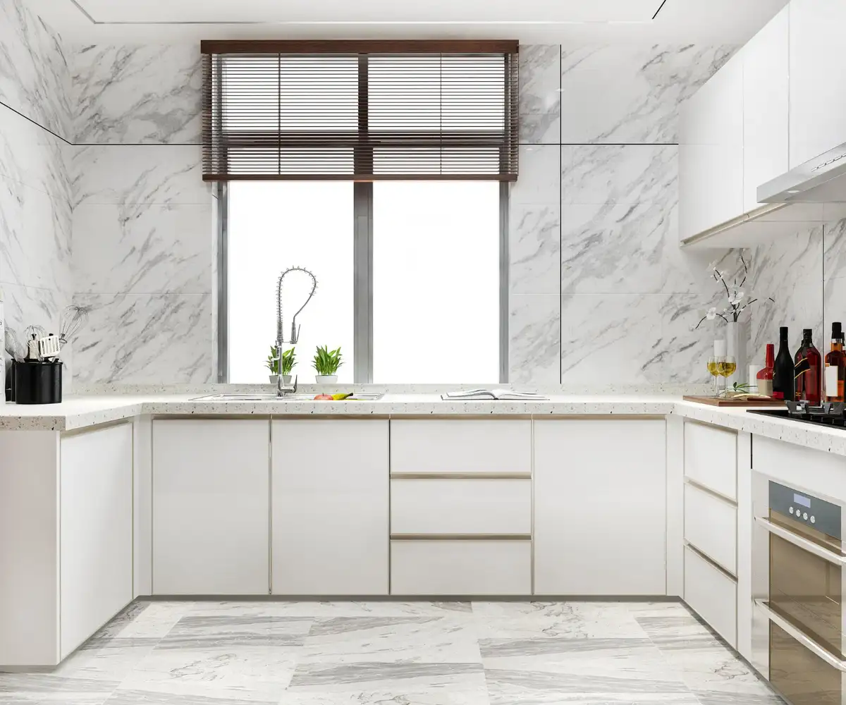 white cabinets with marble countertops and backsplashes.