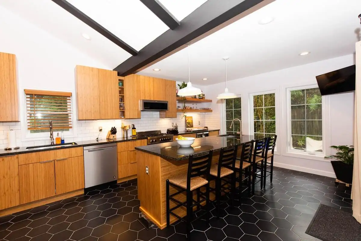 kitchen floor designed with large black pattern tile to make kitchen look larger