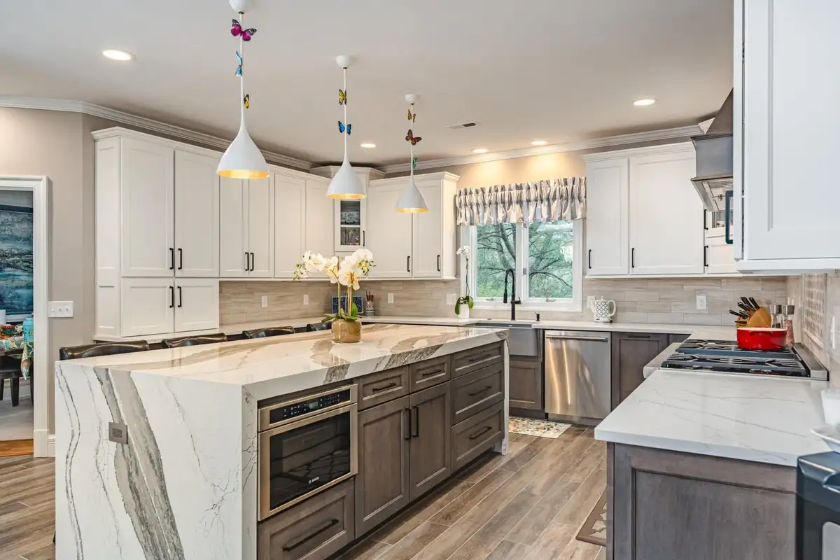 soapstone countertop is used in a stylish white kitchen