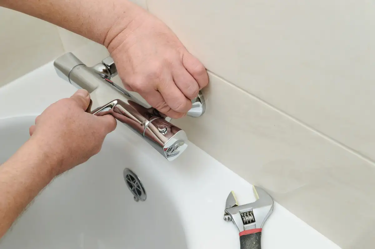 man shows how to replace bathroom fuecet